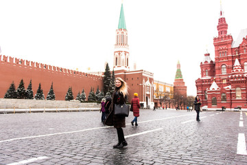 Portrait in full growth, Russian beautiful woman in a mink coat on the Red Square in Moscow in Christmas time