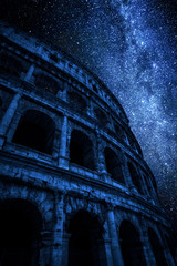 Fototapeta na wymiar Milky way and great Colosseum at night in Rome, Italy