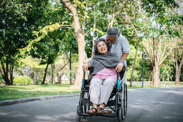 cheerful disabled grandfather in wheelchair welcoming his happy Family