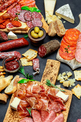 Italian meat appetizer snack set. Salami, prosciutto, bread, olives, capers