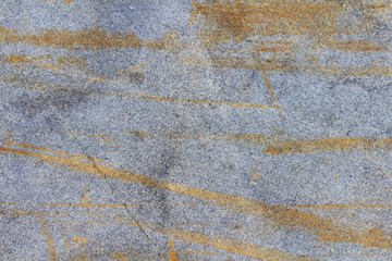Grey granite slab with scratches and stains closeup. Texture of natural stone