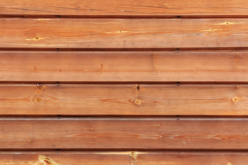 Fototapeta premium Brown lacquered wooden planks closeup. Natural wooden texture