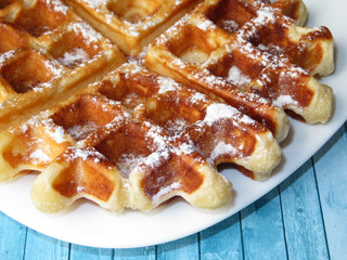 Belgian waffles in a white plate. Homemade dessert