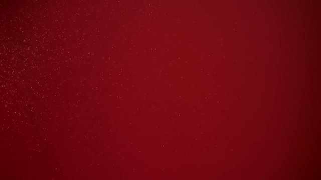 Slow moving real particles on red background