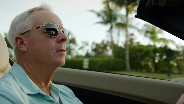 Closeup Of Active Senior Man Driving In His Luxury Convertible In Sunny Florida, Palm Trees In Background - Shot On Red Scarlet-W Dragon In 4K/ Slow Motion
