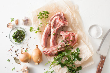 Fresh meat with spices on baking paper on white table
