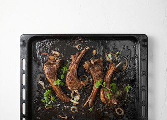 Fried ribs on a baking sheet. The view from the top.