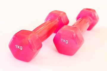 1 KG pink dumbbells on white background