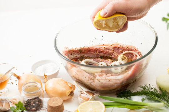 Cooking meat marinade on kitchen white table