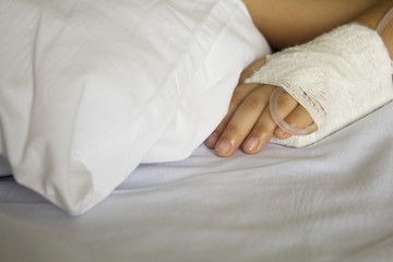 Asian child getting the saline on hand in hospital