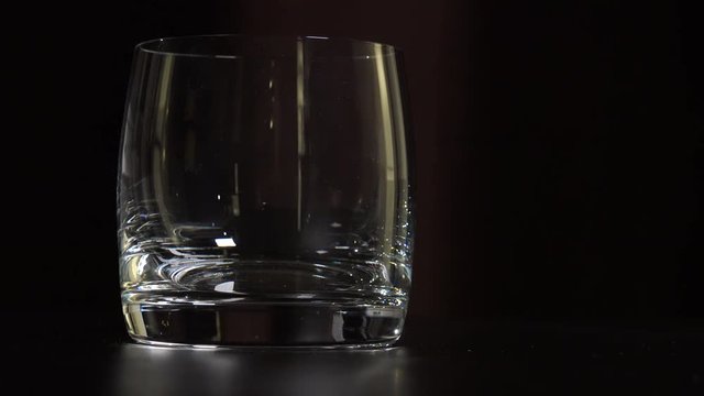 Closeup on an empty glass - dark background