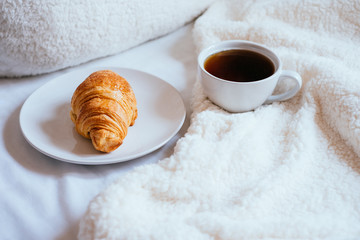 Coffee and croissant in bed