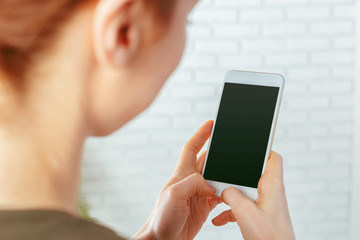 close up of woman texting on smartphone