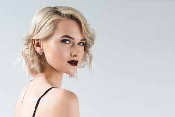 elegant blonde girl posing for fashion shoot, isolated on grey