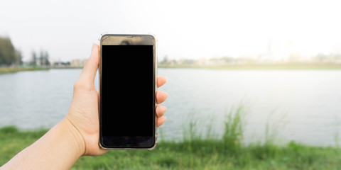 Hand held smartphone in the park.