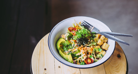 Green Goddess Buddha Bowl on wooden table. Healthy eating, food photography concept. Flatlay, copyspace, horizontal