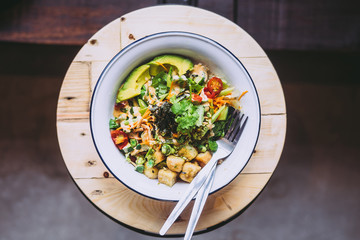 Green Goddess Buddha Bowl on wooden table. Healthy eating, food photography concept. Flatlay, horizontal