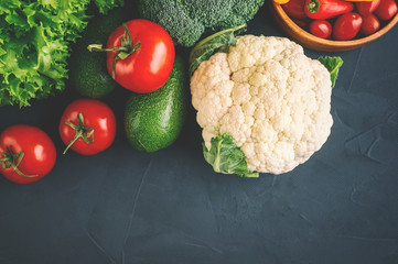 Mixed vegetables of cauliflower and broccoli, garlic, green onions, tomatoes and green peas on a...