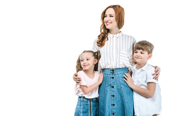 happy mother with adorable kids standing together and looking away isolated on white