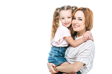 beautiful happy mother and daughter hugging and smiling at camera isolated on white