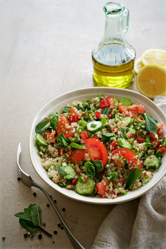 Quinoa tabule salad. Cucumbers, bell peppers, tomatoes, parsley, onions, mint ingredients
