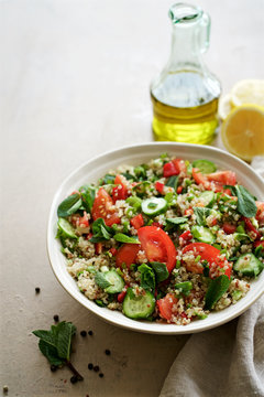 Quinoa tabule salad. Cucumbers, bell peppers, tomatoes, parsley, onions, mint ingredients
