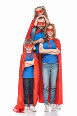 cheerful super family in masks and cloaks smiling at camera isolated on white