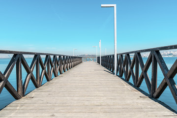 Naklejka premium Wooden scaffolding with lake and city background