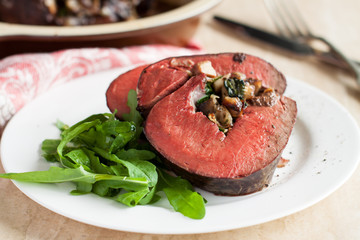 Mushroom and spinach stuffed beef heart with arugula
