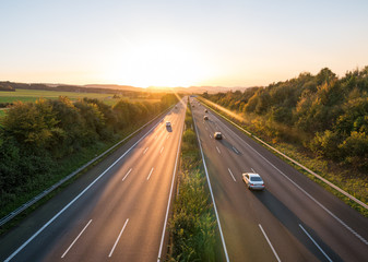 The road traffic on a motorway at sunset