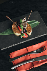 Delicious dessert with fresh berries on stone slab