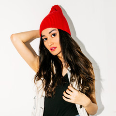 Brunette Pretty girl in fashion beanie cap. Urban style
