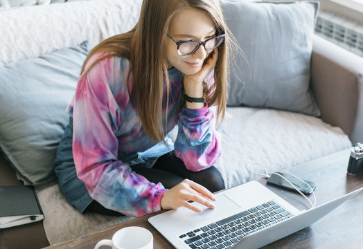 The Girl In The Eye Works At The Computer. Nice Woman In The Interior Of The Apartment Looking For Information On The Internet.