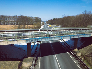 Rural view to a pedestrian walkway bridge and to the highway