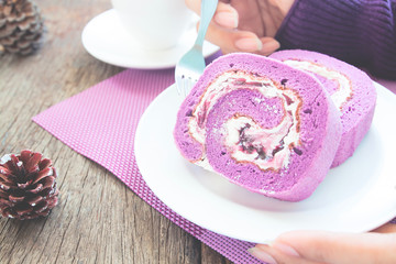 Close up blueberry roll cake with woman's hands