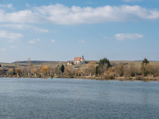 Landscape view over the river to a church