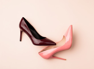 Set of colored women's shoes on pink background