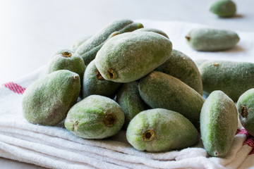 Stack of Fresh Green Almond Nut Fruits on tablecloth.