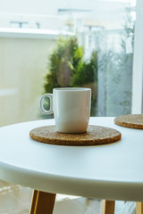 Cup of coffee on white table