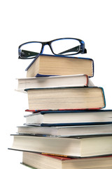 stack of books and glasses on a white background