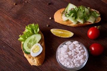 Tasty sandwich with paste, cucumber and fresh lettuce, top view, selective focus