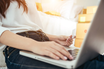 Naklejka premium Young asian girl is freelancer with her private business at home office, working with laptop, coffee, online marketing. Young woman startup her SME business.