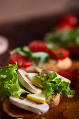 Breakfast sandwich with homemade paste, vegetables and fresh greens, shallow depth of field