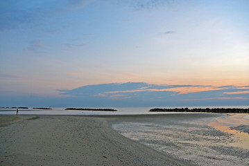 The outfall on sand beach. Beautiful sunrise sky over Adriatic sea
