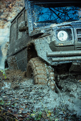 Impassibility of roads concept. Dirty offroad tire covered with mud.