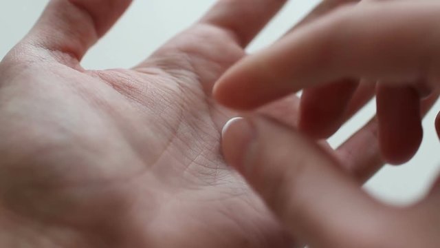 Man Taking white Pill from Blister Pack close up