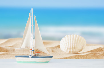 Fototapeta na wymiar nautical concept with white decorative boat over tropical sea landscape background.