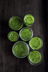 Green spinach smoothie in jars