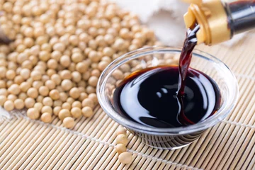  Close up of pouring soy sauce in glass bowl © ddukang