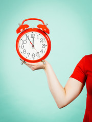 Woman holding old red big clock watch